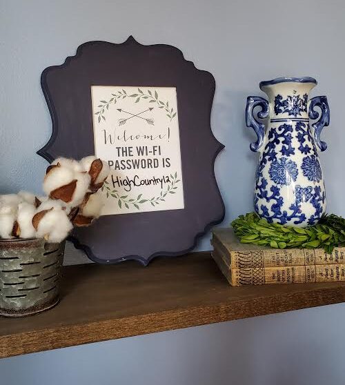 Wifi password sign on shelf with cotton and blue and white vase