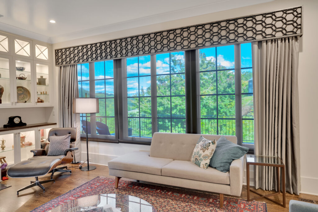 Layered window coverings in Chattanooga dining room with custom Tableaux Decorative Grille on gray cornice