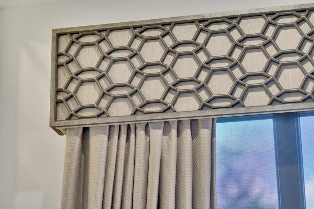 Close-up of small-scale patterned, gray fabric from Carole Fabrics on custom drapery panels and cornice
