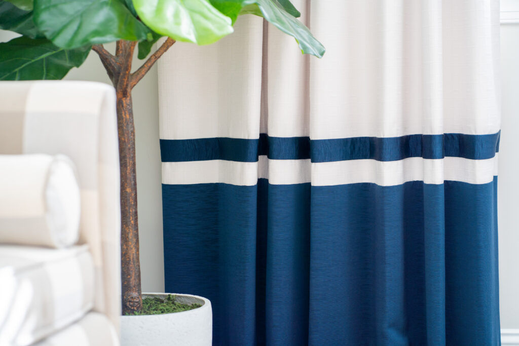 White and navy blocked drapery close up near fiddle leaf tree