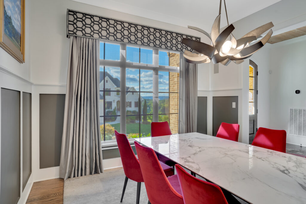 Layered window coverings in Chattanooga dining room with custom Tableaux Decorative Grille on gray cornice