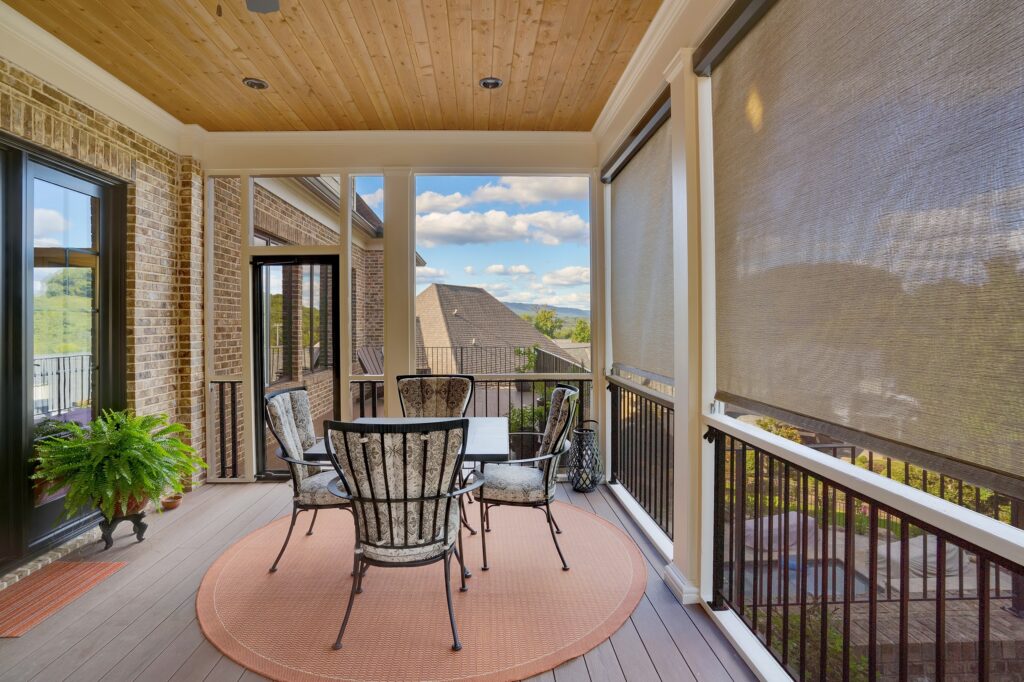 Covered outdoor dining area with motorized shades