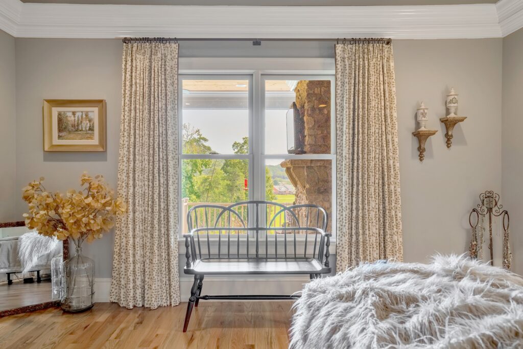 Master bedroom drapery with a bench in front of the window