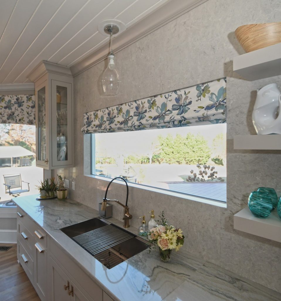 Kitchen sink with a window and Roman shade