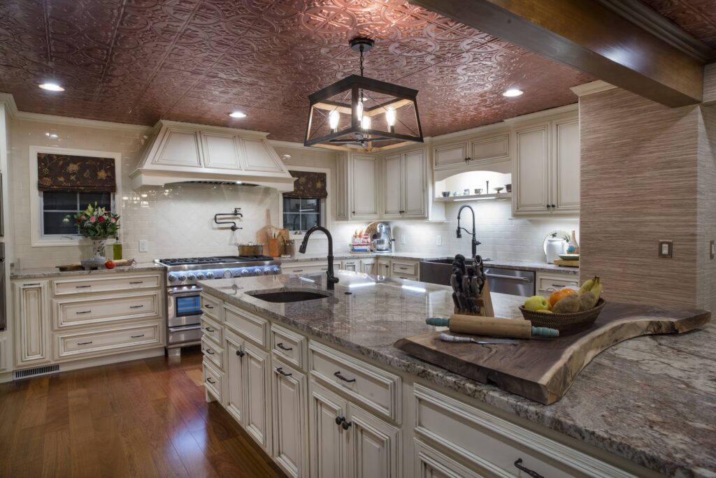 Spacious kitchen with textured ceiling and Roman shades on the windows surrounding the stove