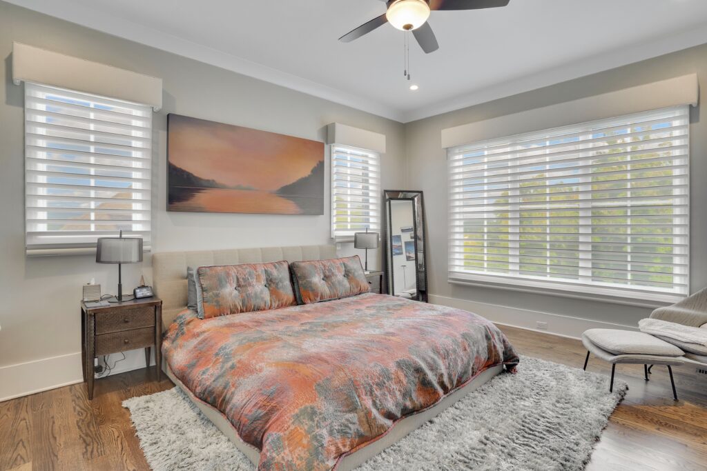 Bedroom in Chattanooga, TN with motorized blinds above the end tables on either side of the bed