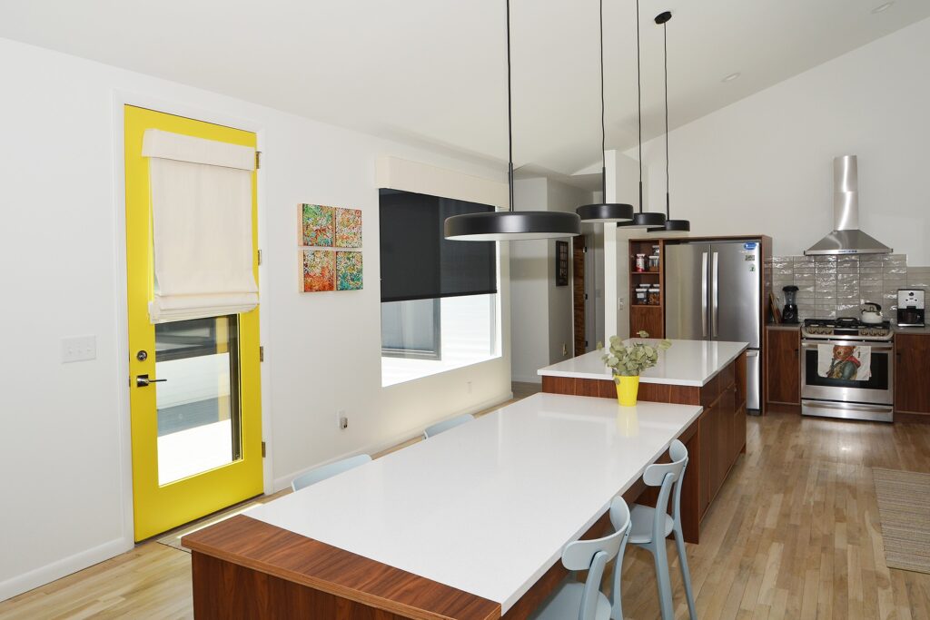 Open kitchen with a solid Roman shade on the window door