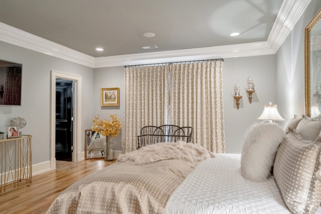 Black Creek Master Bedroom with beige bedding and draperies