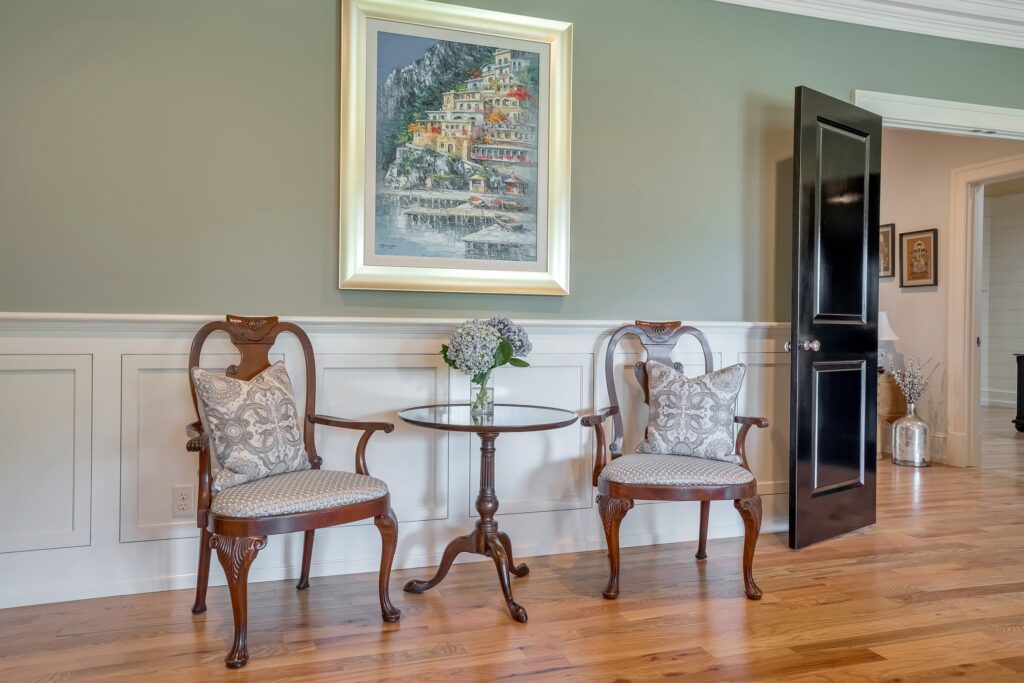 Dining room chairs with side table and artwork