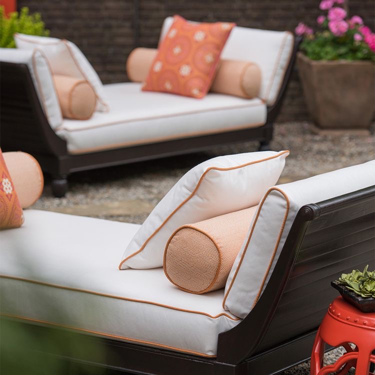 Chinese garden stool beside a settee bench with contrast piping on the pillows and cushions