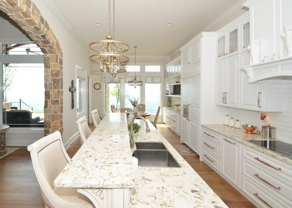 All white kitchen with Roman shades in the dining area