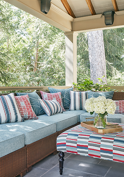 Outdoor sectional with hydrangeas in vase on ottoman