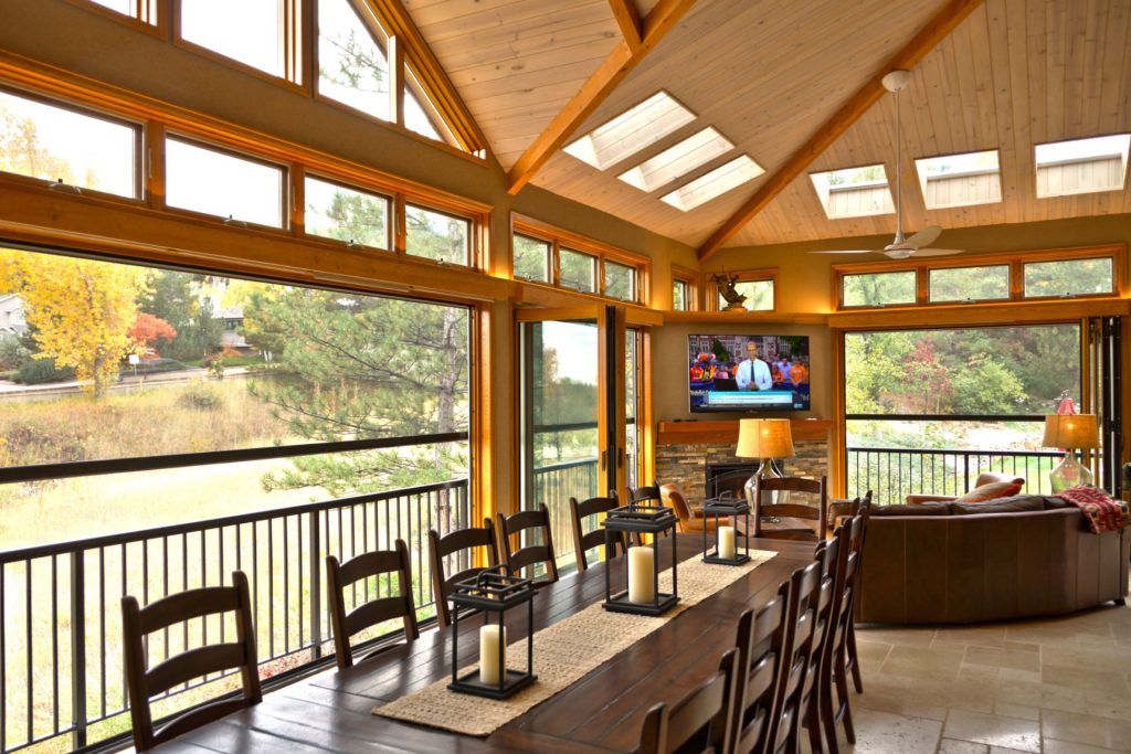 Outdoor sitting area with a table and a tv