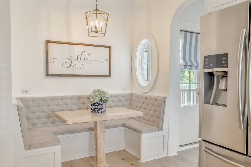 dine-in eating area with custom tan banquette seating against a white wall