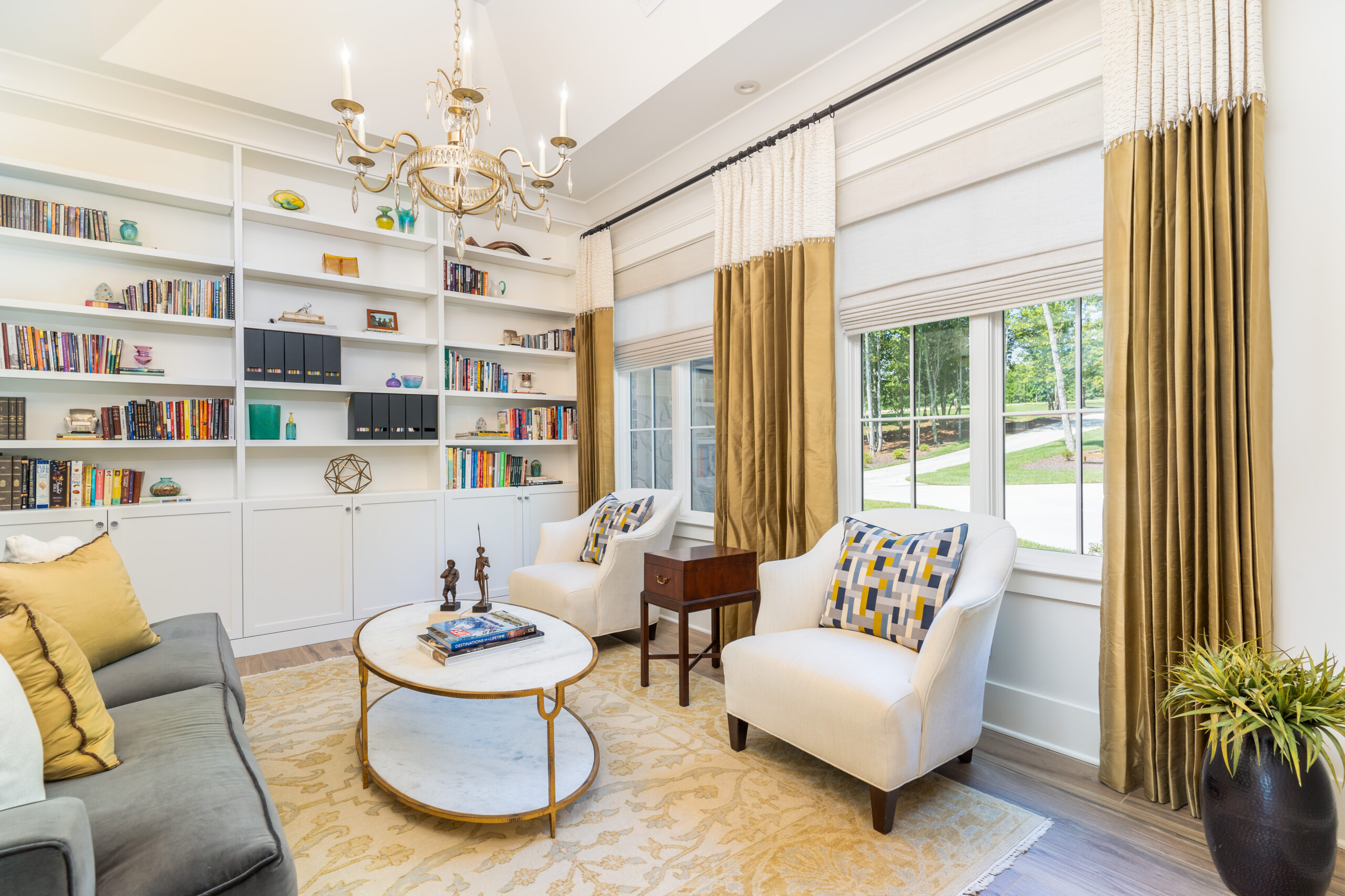 jasper highlands library with gold draperies and coordinating roman shades