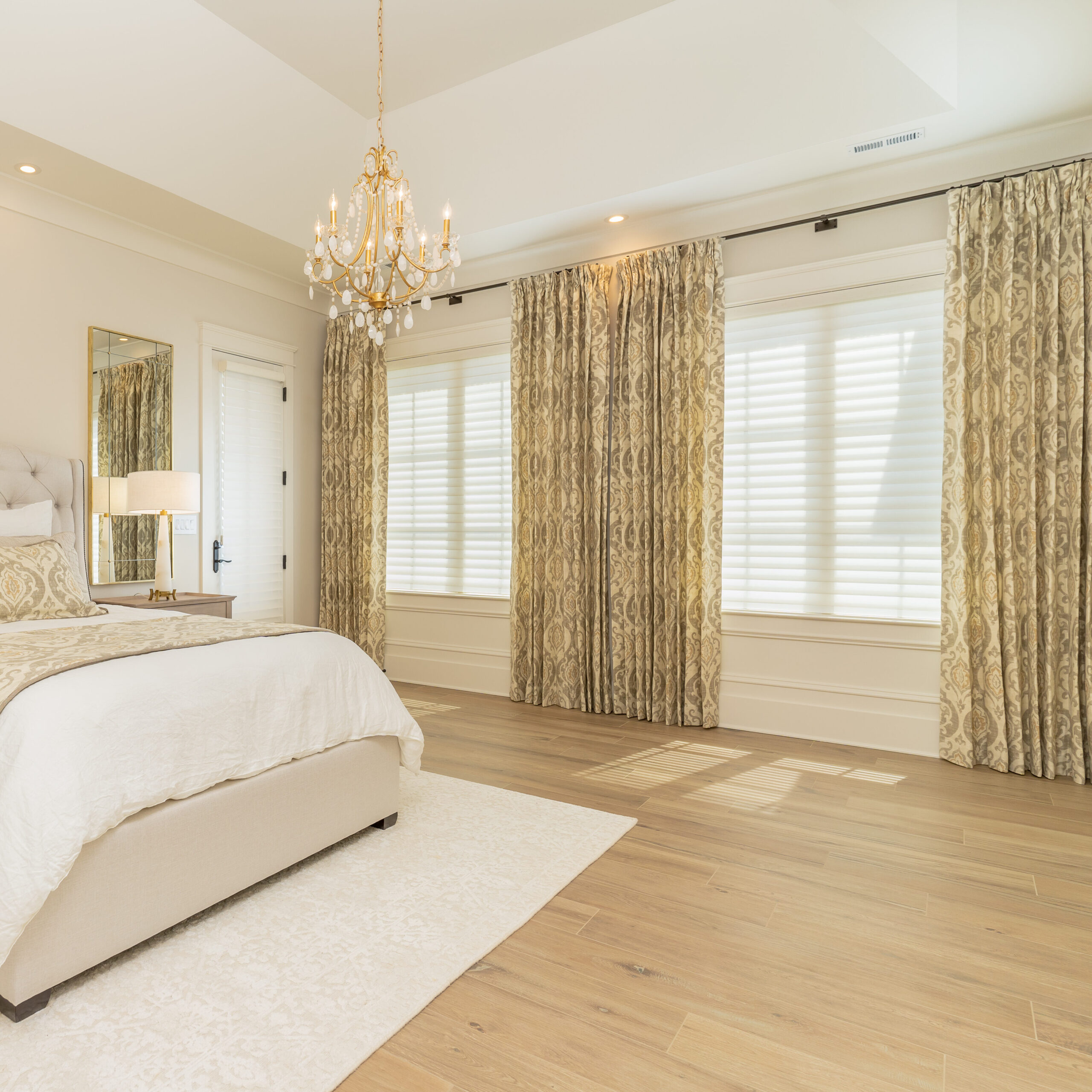 jasper highlands primary bedroom with draperies and motorized shades