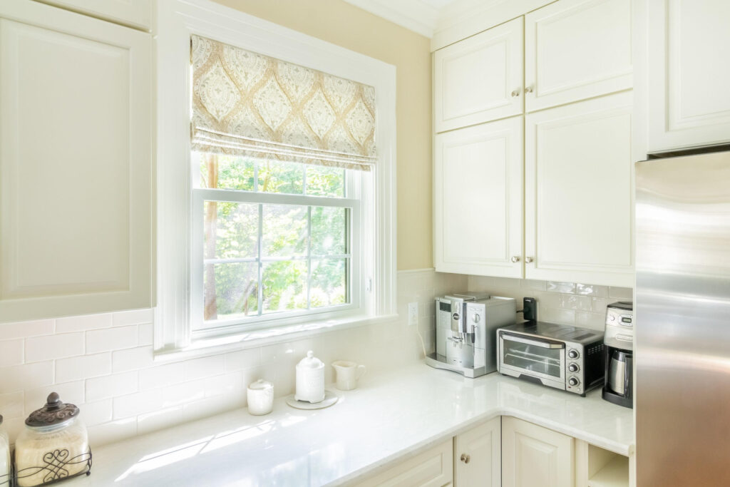 Kitchen with flat fold Roman shade on a window