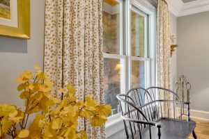 Floral patterned drapery on double-hung kitchen windows