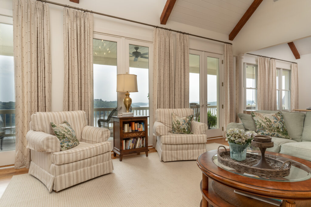 traditional living room in chattanooga with striped chairs, custom pillows, and custom drapery panels